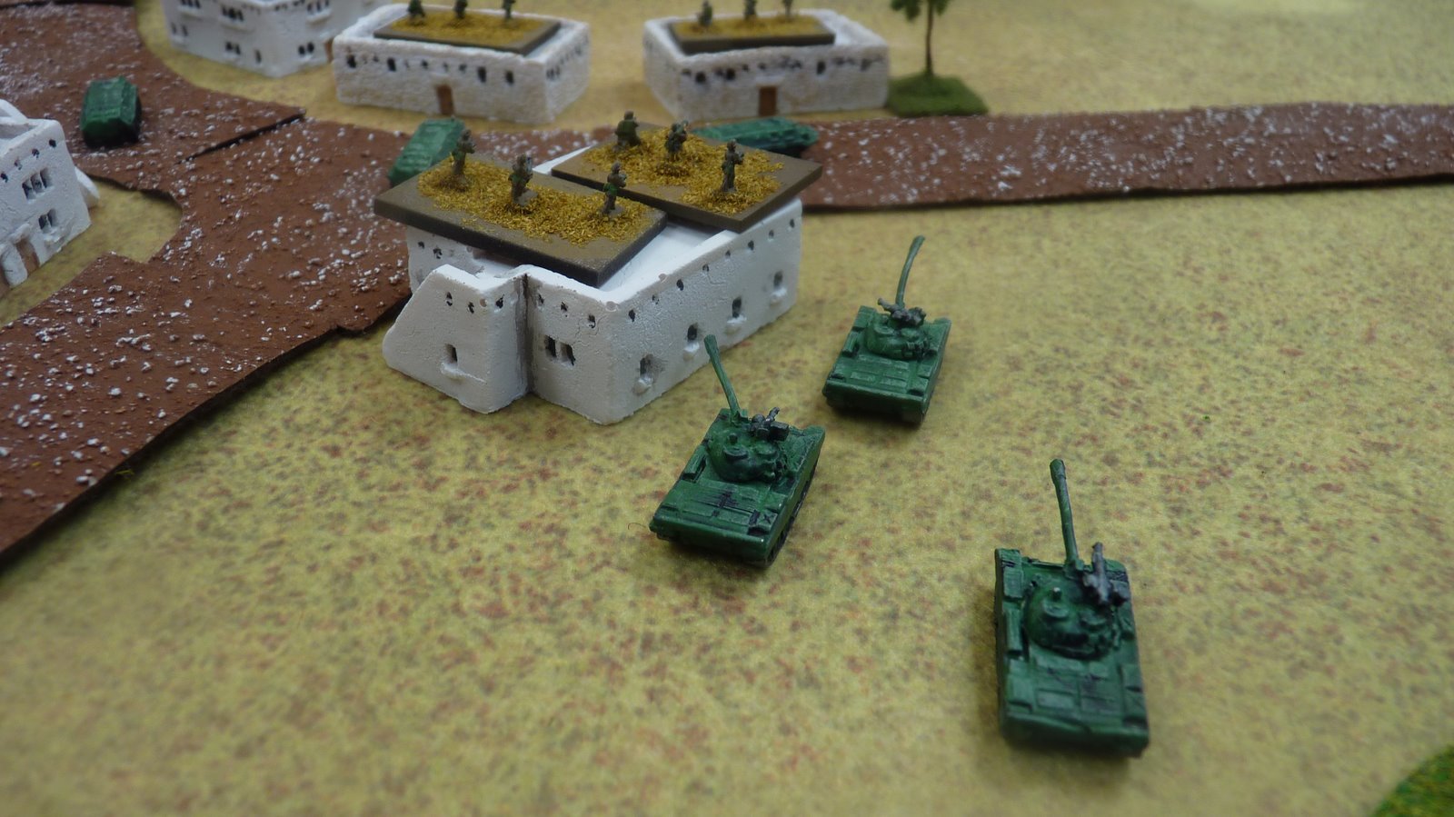A soviet tank platoon reinforces the infantry holding the village